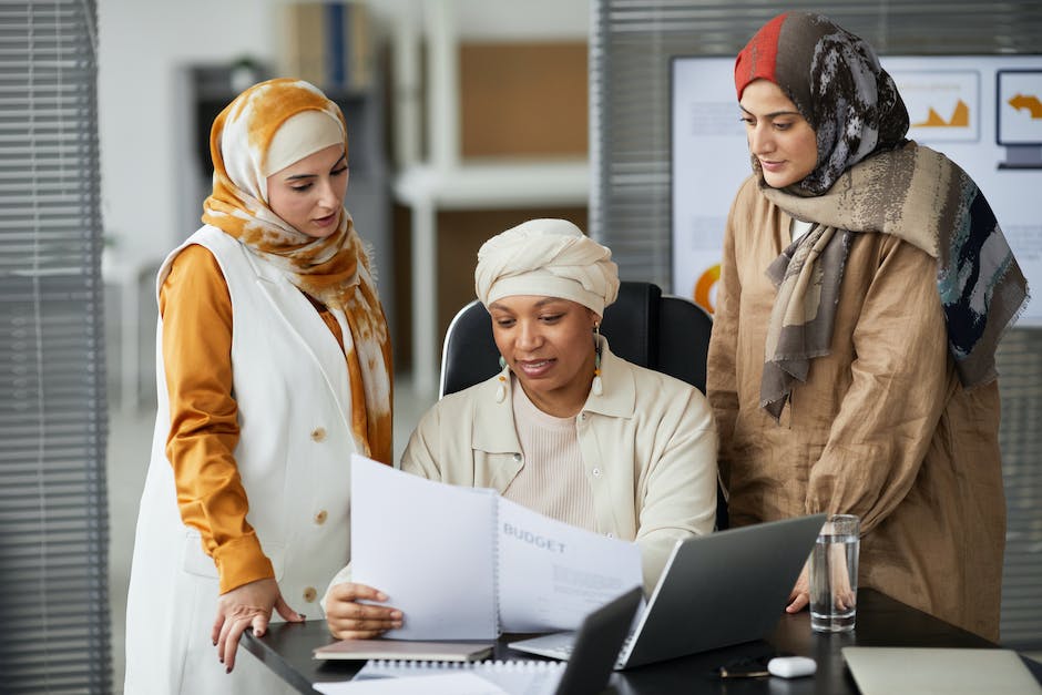 A group of people with documents, discussing and reviewing HOA documentation for tenants