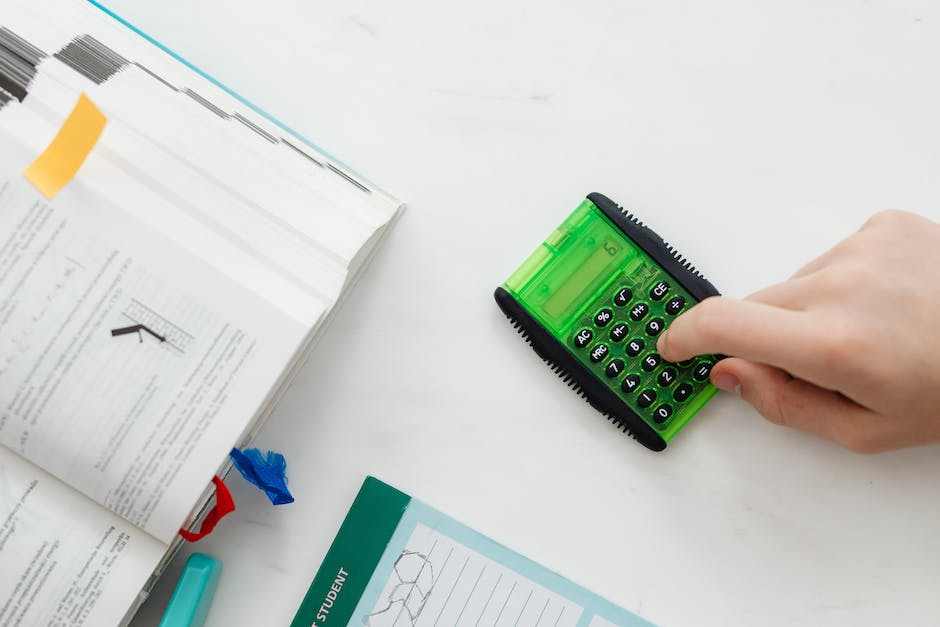 An image of a person holding a calculator and a house, representing the financial aspects of hiring a property manager.