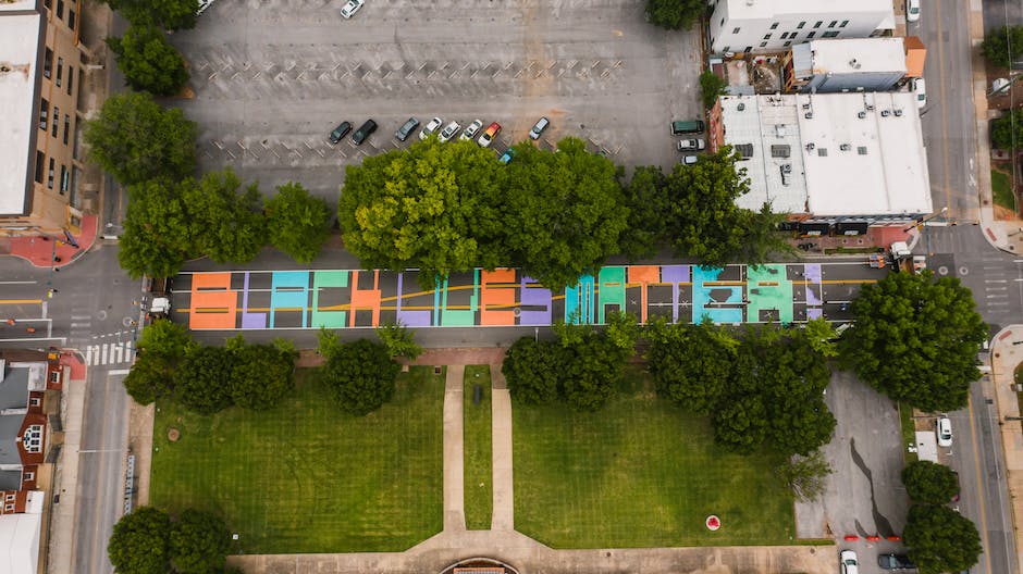 An image depicting a diverse group of people standing in front of various houses, symbolizing fair housing rights and equality.