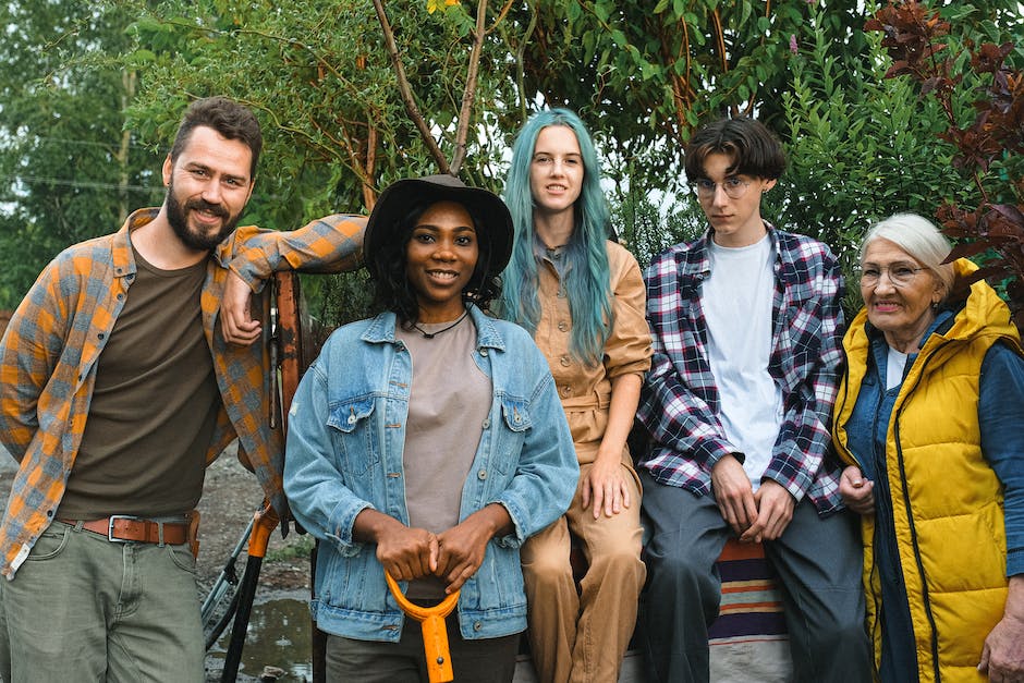 Illustration showing a diverse group of people standing in front of houses, representing equal housing opportunities.