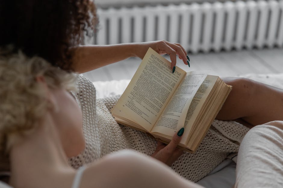 An image featuring a person searching through a stack of books, symbolizing the process of finding the right course for obtaining a rental license in Maryland.