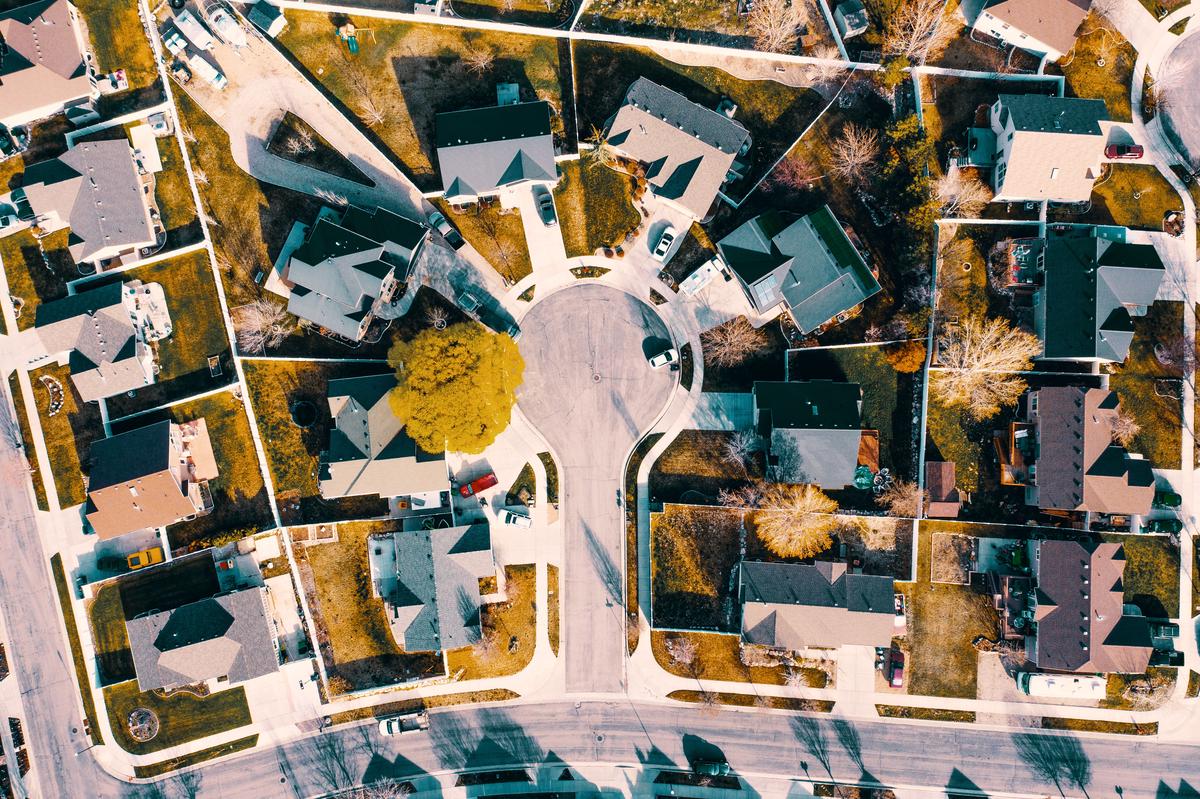 A picture of a neighborhood with well-maintained properties and happy residents, representing the importance of following HOA rules.
