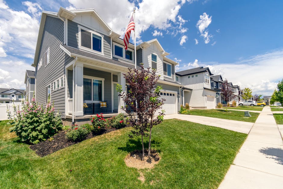 A picture of a suburban neighborhood with well-maintained houses and landscaped lawns.