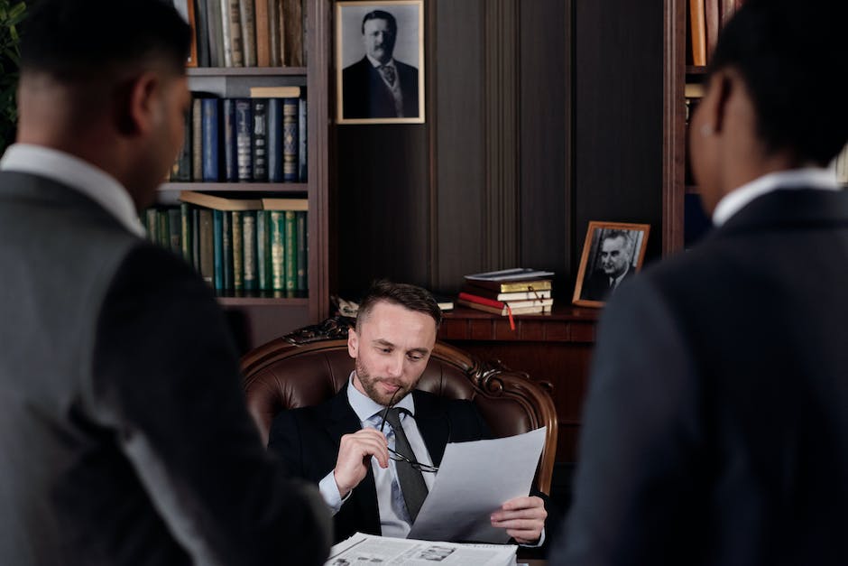 An image showing a landlord reviewing legal documents and communicating with a lawyer in an office setting.