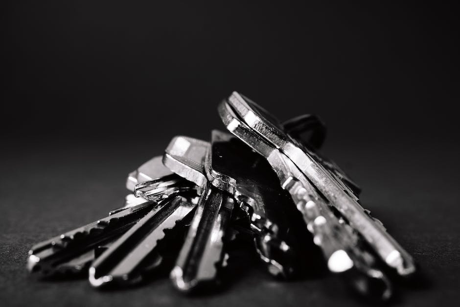 A person holding a set of keys and a clipboard, symbolizing property management.