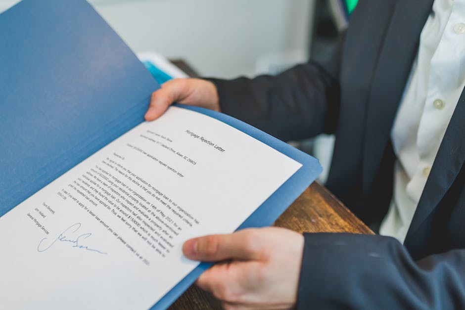 An image of a property manager reviewing documents related to HOA compliance, symbolizing their important role in maintaining a compliant homeowners association.