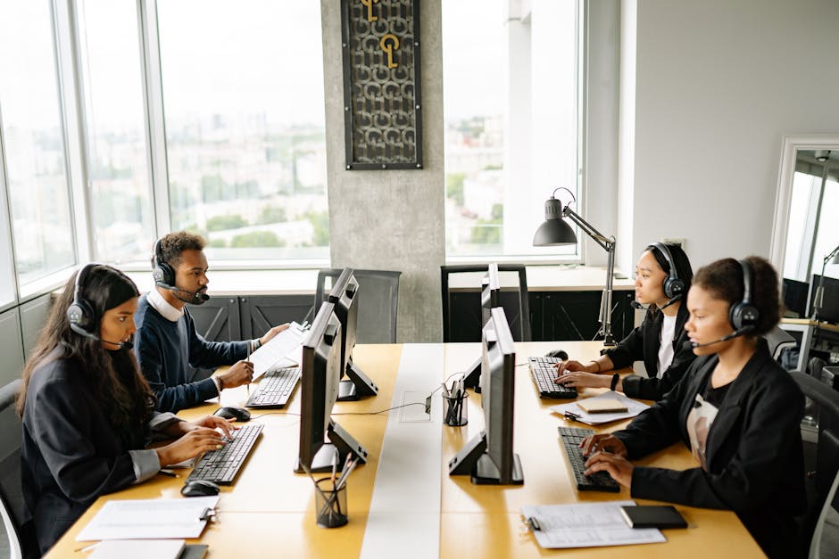 A professional-looking collection agency office with agents working on computers and talking on the phone