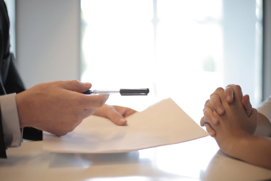 A professional property manager discussing rent arrears with a tenant in an office setting