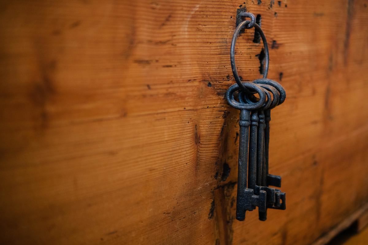 Illustration of a person holding a key and an umbrella, symbolizing renters insurance protecting against unexpected events and providing coverage for personal belongings.