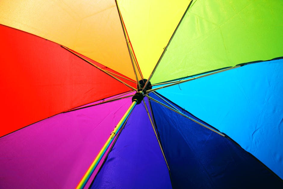 Illustration of a person holding an umbrella over a house to represent renters insurance providing protection