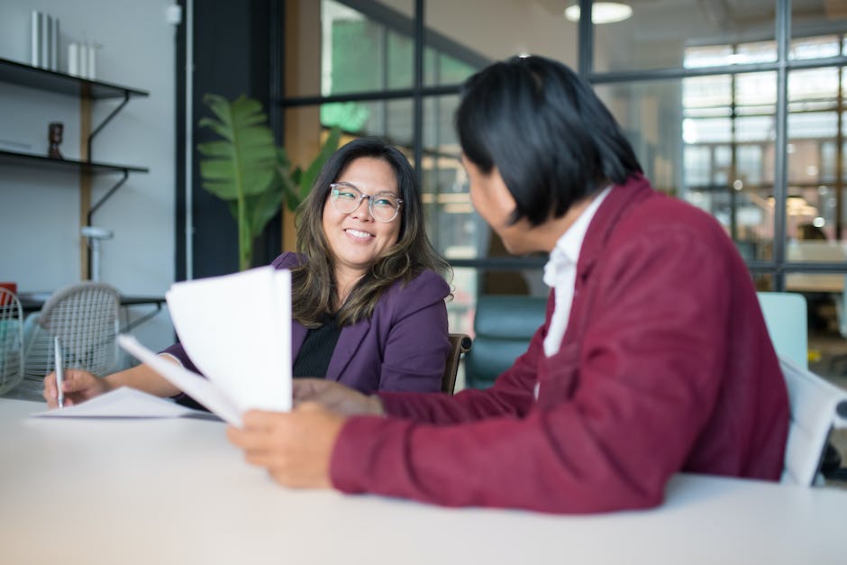 Image depicting a property manager handling paperwork and interacting with tenants to demonstrate effective tenant management.