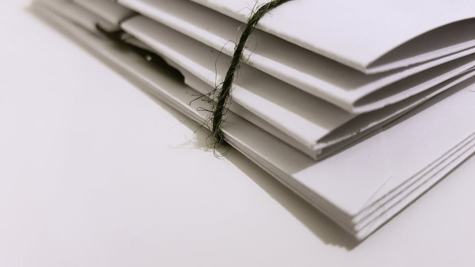 A landlord and tenant sitting at a table with documents, discussing unpaid rent mediation